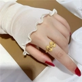 Elegant gold bow ring with sandblasted finish on model hand for minimalist women - Hollow Bowknot Ring Adjustable