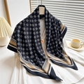 Elegant black geometric silk scarf with gold patterns styled on a white shirt - Black