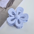 Macro view of light blue matte flower hair claw clip with a hollow five-petal design - Blue Gray