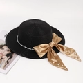 Detail of straw boater hat with pearl chain trim and champagne satin bow decoration - One Size / Black