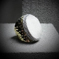 Macro shot of wide gold textured ring with white crystal and sparkling rhinestones - Adjustable Open / White
