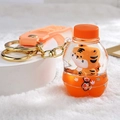 Tiger liquid quicksand keychain featuring orange oil bottle and matching wrist strap - Orange Soda Bottle