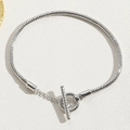 Detail of silver snake chain bracelet featuring a polished heart toggle clasp and T-bar closure - Toggle Clasp Bracelet White Gold