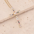 Macro detail of 18K gold cross pendant with colorful zircon stones on stone background - Rainbow Multicolored Gemstone Cross Style (7#)
