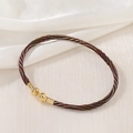 Detail of colorful woven cord bracelet featuring gold-tone metal ends and spiral texture - Rainbow