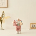 Standing Santa figurine in pink velvet overalls holding a gift bag and small white bear - Pink Figurine With Bear / 30cm
