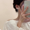 Elegant silver bow earrings with pearl tassels shown on ear in a natural daily style - Handmade Pearl Bow Fresh Drop Earrings - White (32#)