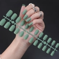 Macro shot of matte green long square press-on nails arranged on an injection strip - Matte Green
