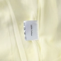 Detailed view of the 100% cotton wash care label on a soft yellow cotton dress - S / Yellow