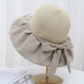 Elegant wide brim straw sun hat with large bow knot on metal stand for summer protection - Khaki