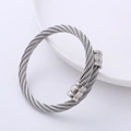 Dettaglio di un bracciale rigido a doppio cavo in acciaio argento con punte lucide - Color Acciaio