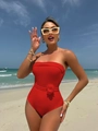 Red bandeau one-piece swimsuit featuring a 3D floral accent on a sunny beach setting - S / Red