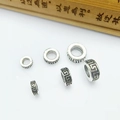 Macro shot of Tibetan silver spacer beads with Greek key patterns in three sizes - 6x2.2x3mm / Antique Silver