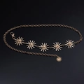 Detail of adjustable gold multilayer chain belt with sun face charms on black surface - Gold Sun Single Layer