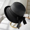 Elegant black woven straw sun hat with large bow detail on a gold display stand - M (56-58cm) / Black