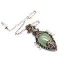 Close-up of vintage bronze star pendant necklace with green teardrop crystal gem - Green Aventurine + Pendulum Chain