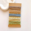 Close-up of assorted elastic hair ties in muted tones on a display card for styling - Bamboo Texture Light Color Set