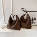 Detail shot of large capacity dark brown soft leather hobo bags in a stylish minimalist setting - Small / Coffee