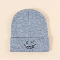 Detail of grey knitted beanie with black embroidered smiley face on folded brim - One Size / Light Gray
