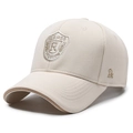 Beige baseball cap with embroidered shield badge and brown brim piping detail - Beige