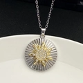 Macro view of sunburst pendant with sparkling crystals on gold and silver two-tone metal - Silver (8298)