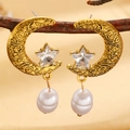Vintage gold moon and star earrings with pearl drops shown on a dark wooden branch - Antique Gold (DZ-229)