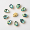 Detail of 10x14mm teal pear-shaped rhinestones with gold prong settings and sew-on holes - 10x14mm / Royal Blue AB