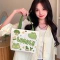 Compact white canvas tote bag with green handles featuring cartoon crocodile print - Lucky Frog