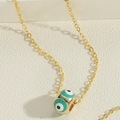 Golden delicate chain necklace featuring a blue round evil eye enamel bead pendant - Green