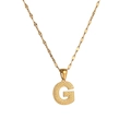 Detailed view of golden letter G pendant with unique dotted texture and delicate chain - Letter G
