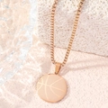 Close-up of rose gold basketball pendant necklace on minimalist stone background - Box Chain / Rose Gold