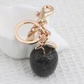 Black glittery apple keychain with gold metal hardware and leaf detail for bags - Black Apple with Light Gold