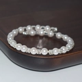 Macro view of multi-layer pearl bracelet with rhinestone spacers on a wooden base - 1 Row Silver
