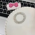 Clear spiral phone cord hair tie with colorful sequins in a decorative white dish - Explosion Dots