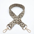 Detail showing adjustable embroidered diamond pattern bag strap with gold metal lobster clasps - Dark Khaki