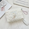 Detail of quilted beige makeup bag with cartoon angel embroidery and pink handle strap - Angel Lamb
