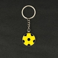 Yellow and black football soccer keychain with silver metal ring on textured surface - Round Soccer/Red