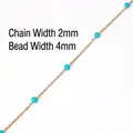 Macro detail of 2mm gold chain with 4mm blue beads for DIY jewelry making - Light Blue