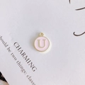 Detail of a pink enamel gold letter U charm pendant for DIY necklace and jewelry making - Letter U