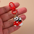 Panda on mushroom enamel keychain with red hook and golden metal finish on beige background - Mushroom Panda