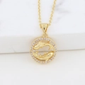 Detail of golden koi fish pendant with sparkling stones on white marble surface - Pisces