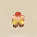 Macro view of plumeria hair claw with acrylic gradient petals and glitter finish - Colorful Plumeria Orange Yellow