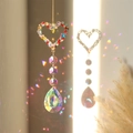 Detailed view of heart-shaped crystal suncatcher reflecting rainbow light spots - Multicolor Heart