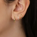 Three-piece set of golden zircon hoop earrings shown on ear with elegant water drop design - 5934201HB/Gold Waterdrop Minimalist Combo
