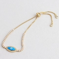 Close-up of gold Evil Eye bracelet featuring blue enamel and sparkling pavé stones - Gold Plated - Sky Blue