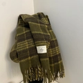 Detail of dark green and brown plaid wool scarf featuring soft fringed edges and texture - British Plaid Military Green