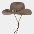 Detail of woven straw cowboy hat with shell band, metal studs, and adjustable chin strap - Coffee