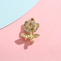 Close-up of golden rose pendant with sparkling zircons and hanging loop for DIY jewelry - Pink Rose Gold