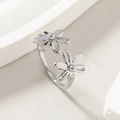 Polished stainless steel open ring with double daisy flowers on white stone background - US 6 / Steel
