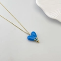 Elegant gold chain necklace featuring a blue heart pendant with golden drip detail - Blue